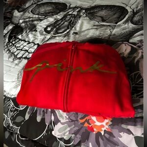 PINK - Red sweatsuit with gold script lettering